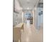 Bright hallway featuring tile flooring, neutral walls, arched doorways, and decorative accents at 3871 Brant Pl, Leesburg, FL 34748