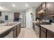 Well-equipped kitchen featuring stainless steel appliances and dark wood cabinetry, offering a modern and functional space at 3871 Brant Pl, Leesburg, FL 34748