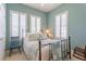 This bedroom features light blue walls, plantation shutters, and a black metal bed frame at 4268 Ethan Ln, Orlando, FL 32814