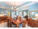 Spacious dining room featuring a large table, elegant chandelier, and hardwood flooring at 4268 Ethan Ln, Orlando, FL 32814