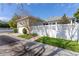 A private driveway and rear garage with an enclosed backyard and decorative white fence at 4268 Ethan Ln, Orlando, FL 32814