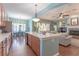 Modern kitchen with island seating, stainless appliances, and views to living area at 4268 Ethan Ln, Orlando, FL 32814