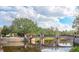 Picturesque pond with pedestrian bridge and clear views of Baldwin Park homes at 4268 Ethan Ln, Orlando, FL 32814