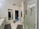 Bathroom featuring white cabinets, glass shower and large mirror at 4412 Conroy Club Dr, Orlando, FL 32835