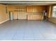 Spacious garage featuring tiled flooring, ample cabinet storage, and organizational shelving at 4412 Conroy Club Dr, Orlando, FL 32835