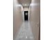 Bright hallway featuring clean lines, modern lighting, and marble-like tiled floor leading to bathroom at 4412 Conroy Club Dr, Orlando, FL 32835