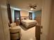 Stylishly furnished main bedroom features tile floors and a ceiling fan at 4412 Conroy Club Dr, Orlando, FL 32835