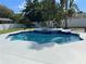 Inviting pool with an integrated spa surrounded by lush landscaping and a white fence at 4412 Conroy Club Dr, Orlando, FL 32835