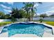 Inviting pool with an integrated spa surrounded by lush landscaping and a white fence at 4412 Conroy Club Dr, Orlando, FL 32835