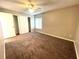 Neutral toned bedroom with carpet flooring, a ceiling fan, and a sliding door closet at 4439 Pinebark Ave # 47-4, Orlando, FL 32811