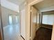 Hallway view with access to the carpeted bedroom and tiled living room at 4439 Pinebark Ave # 47-4, Orlando, FL 32811