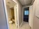 Hallway view showing the bathroom and bedroom entrance, highlighting the home's layout at 4439 Pinebark Ave # 47-4, Orlando, FL 32811