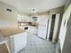 Modern kitchen with white appliances, ample cabinet space, and stylish flooring, perfect for cooking and dining at 4439 Pinebark Ave # 47-4, Orlando, FL 32811