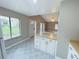 Well-lit kitchen featuring a peninsula counter, white cabinetry, and an open view to the living room at 4439 Pinebark Ave # 47-4, Orlando, FL 32811