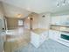 Open-concept layout with a living room flowing into the kitchen, enhanced by tiled flooring and natural light at 4439 Pinebark Ave # 47-4, Orlando, FL 32811