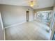 Open concept living area, with tile flooring, that flows into the kitchen at 4439 Pinebark Ave # 47-4, Orlando, FL 32811