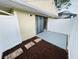 Private outdoor patio area with neutral stones and white fencing providing a cozy and secluded retreat at 4439 Pinebark Ave # 47-4, Orlando, FL 32811