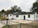 View of the back of the house featuring a newly installed back door and concrete parking pad at 4900 Grand Ave, De Leon Springs, FL 32130