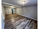 Finished basement featuring stylish wood-look flooring and neutral paint at 4900 Grand Ave, De Leon Springs, FL 32130