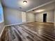 Spacious finished basement featuring stylish wood-look flooring and neutral paint at 4900 Grand Ave, De Leon Springs, FL 32130