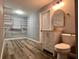 Bathroom with modern vanity, lighting, toilet, and walk-in closet at 4900 Grand Ave, De Leon Springs, FL 32130