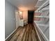 Hallway leads to bathroom with vanity, toilet, and a closet with shelves at 4900 Grand Ave, De Leon Springs, FL 32130