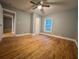 Bedroom with hardwood floors, a ceiling fan, and a window at 4900 Grand Ave, De Leon Springs, FL 32130