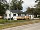 Beautiful exterior view of house highlighting new wooden deck, black roof, and blue shutters at 4900 Grand Ave, De Leon Springs, FL 32130