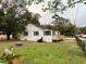 A charming house with a new wooden deck, exterior paint and a partially fenced-in yard at 4900 Grand Ave, De Leon Springs, FL 32130