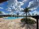 Large community pool featuring a splash park, palm trees, and manicured landscaping at 4934 Chase Ct, St Cloud, FL 34772