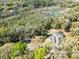 An aerial perspective of the home and pool, highlighting its secluded location among mature trees and native foliage at 520 Long Lake Ct, Oviedo, FL 32765