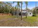 Spacious backyard features mature trees, a fenced perimeter, and a screened-in pool and patio at 520 Long Lake Ct, Oviedo, FL 32765