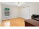 Bright bedroom with wood floors, ceiling fan, and closet providing a clean and simple space at 520 Long Lake Ct, Oviedo, FL 32765