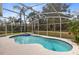 A refreshing pool and spa are enclosed within a screened lanai in the backyard at 520 Long Lake Ct, Oviedo, FL 32765