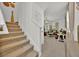 Spacious living room featuring a staircase, neutral walls, carpet flooring, and view into the living space at 5237 Royal Point Ave, Kissimmee, FL 34746