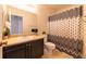 Bathroom featuring vanity, toilet, and shower with curtain at 5550 E Michigan St # 3309, Orlando, FL 32822