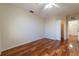 Bright bedroom with hardwood floors and an open closet space at 5550 E Michigan St # 3309, Orlando, FL 32822