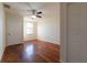 Bedroom featuring hardwood floors and a window for natural light at 5550 E Michigan St # 3309, Orlando, FL 32822