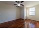 Bedroom featuring hardwood floors, window, and a ceiling fan at 5550 E Michigan St # 3309, Orlando, FL 32822