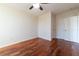 Bedroom with hardwood floors and double door closet at 5550 E Michigan St # 3309, Orlando, FL 32822