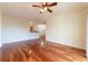 Open-concept living room showcasing hardwood floors and a ceiling fan at 5550 E Michigan St # 3309, Orlando, FL 32822