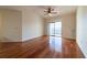 Bright living room featuring hardwood floors, ceiling fan, and sliding glass doors at 5550 E Michigan St # 3309, Orlando, FL 32822