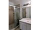 This bathroom features a tiled shower with glass door, and a vanity with a mirror at 570 Cranes Way # 246, Altamonte Springs, FL 32701