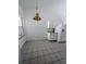 Eat-in kitchen with tile flooring, a hanging light, white cabinetry, and stainless steel refrigerator at 570 Cranes Way # 246, Altamonte Springs, FL 32701