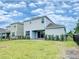 Exterior view features a well-maintained lawn, privacy fence, and a covered patio providing a relaxed setting at 603 Fortuna Dr, Davenport, FL 33837