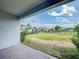 Backyard features a lawn enclosed by a black fence and a brick paved patio with a covered area at 603 Fortuna Dr, Davenport, FL 33837