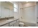 Bathroom features a tub-shower combo with white tile and a modern vanity with a granite countertop at 603 Fortuna Dr, Davenport, FL 33837