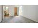 A carpeted bedroom with a closet, a window, and an open doorway to a bathroom at 603 Fortuna Dr, Davenport, FL 33837