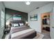 Comfortable bedroom features modern art, plush bedding, and a spacious closet for storage at 603 Fortuna Dr, Davenport, FL 33837