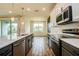 Modern kitchen with stainless steel appliances, gray and white cabinets, and a large island with pendant lighting at 603 Fortuna Dr, Davenport, FL 33837